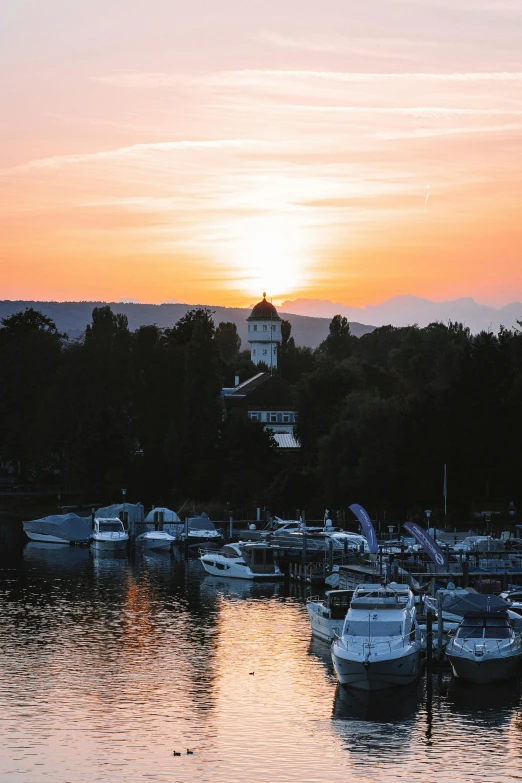 a harbor filled with boats under a colorful sky