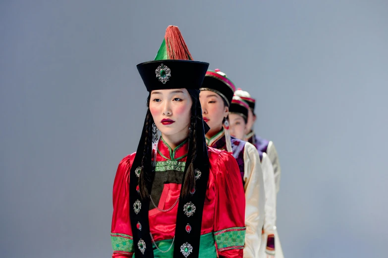 four asian ladies dressed in colorful costume