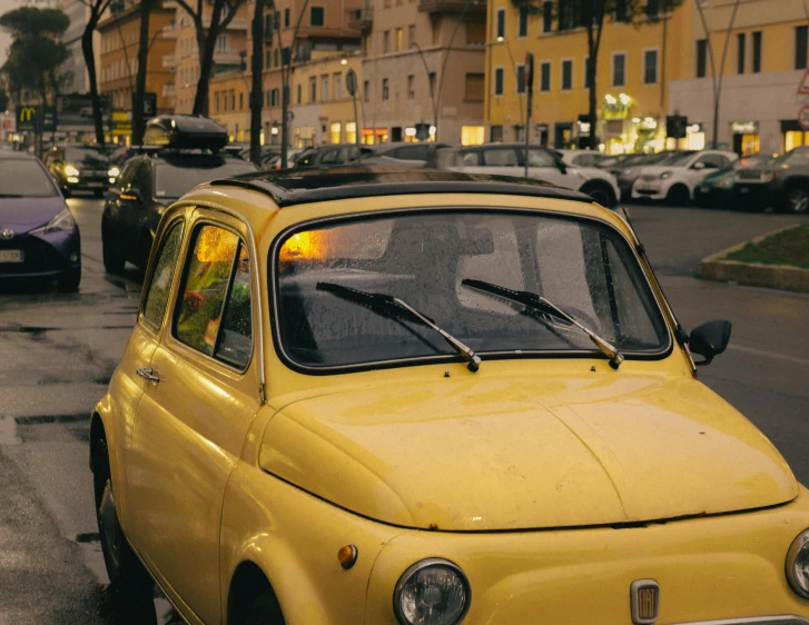 a yellow car that has yellow lights on its hood