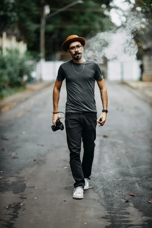 a young man walking down the street while smoking