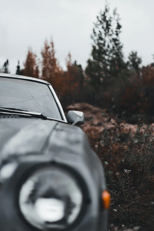 a car driving down a road with its headlamp