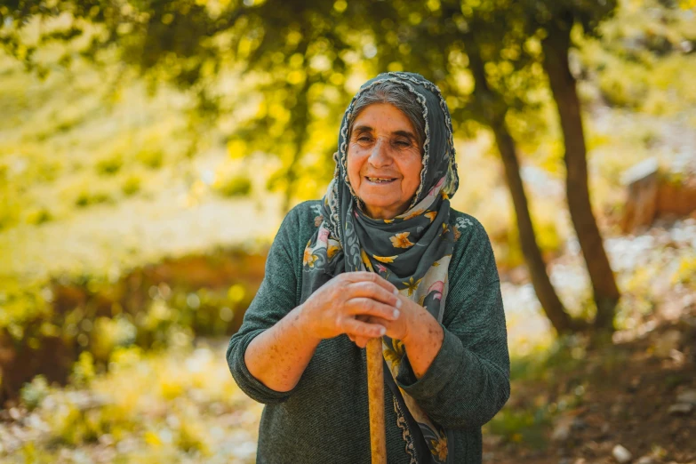 an older lady smiles holding her cane