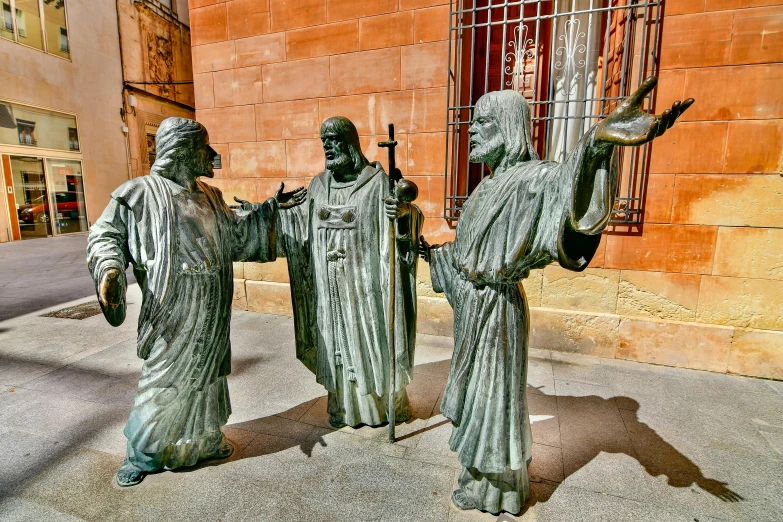 two statues of a man and a woman next to each other