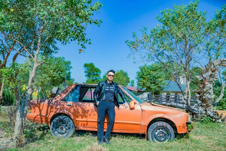 a man is standing in front of a car