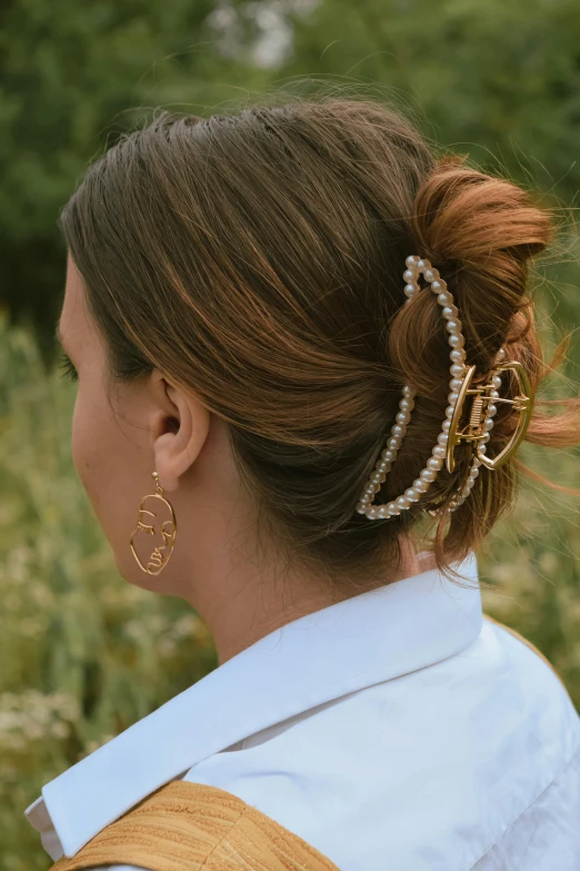 a close up of a woman with her hair in a bun
