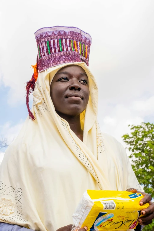 a woman in a head dress carrying an object