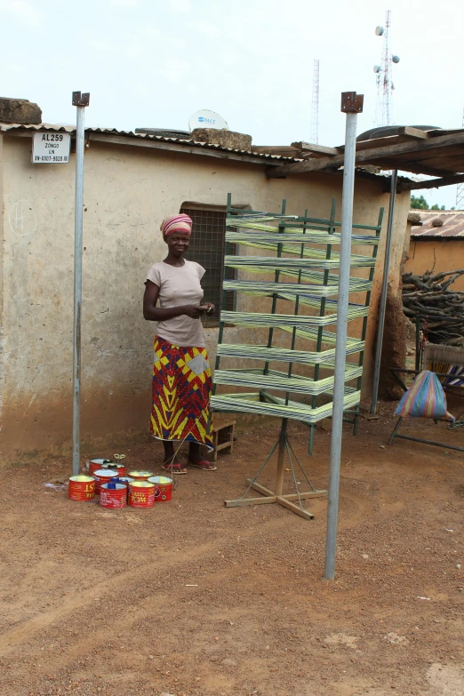 a woman standing outside near her stove and refrigerator