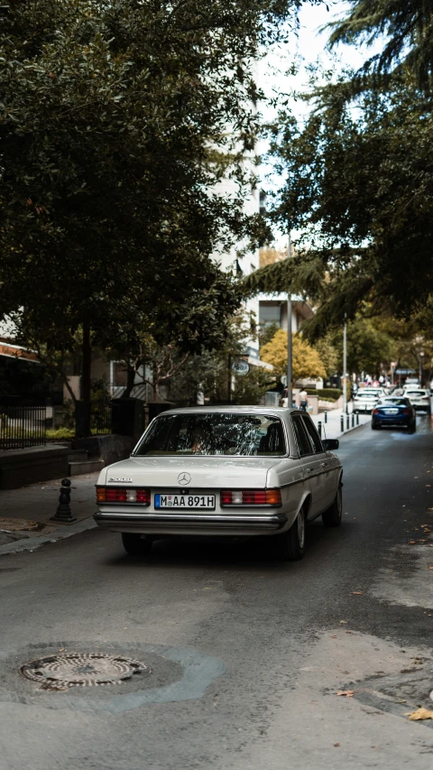 a car parked on the street near trees