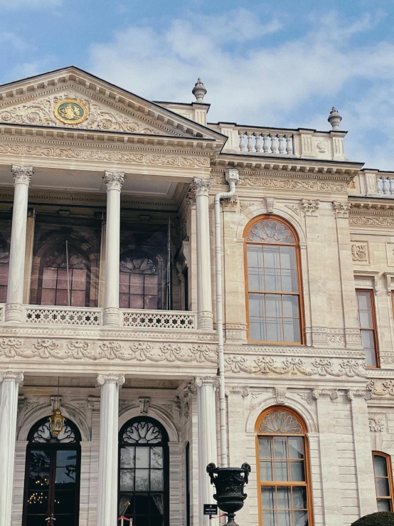 a large building has columns and a clock