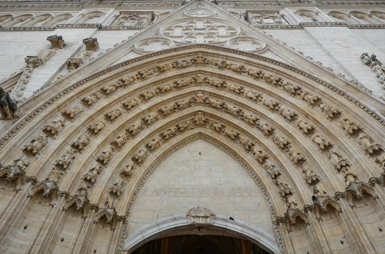 a large cathedral building is shown with sculptures on it's doors