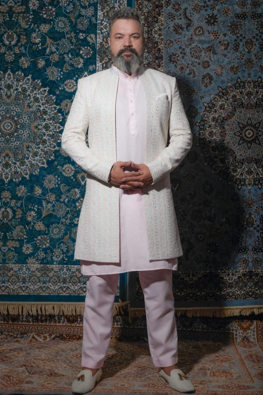 a man standing in front of a rug