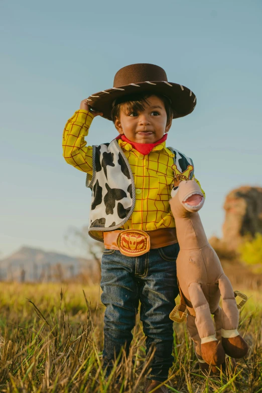 a toddler dressed in woody the pencil drawn toy cow