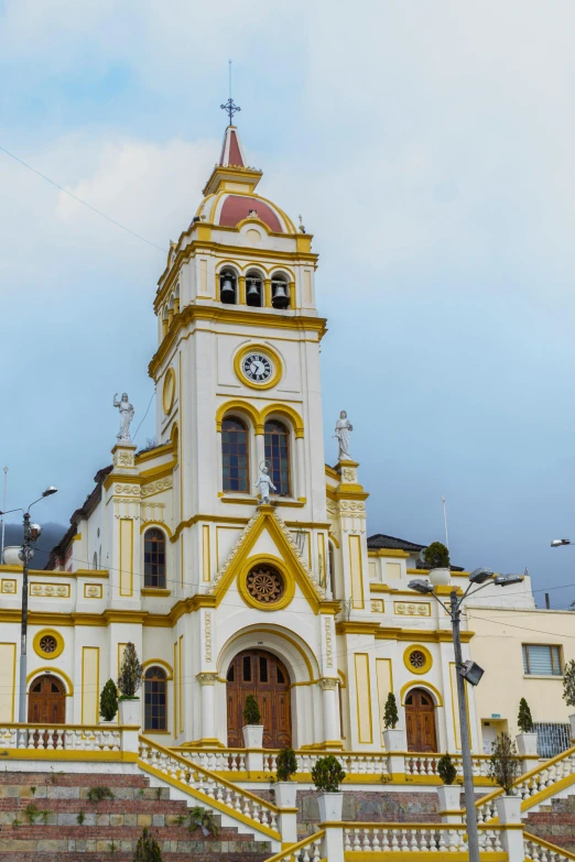 an ornate church building painted yellow and white