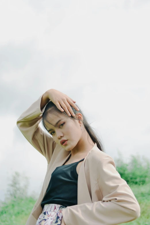 a girl standing outside in the grass