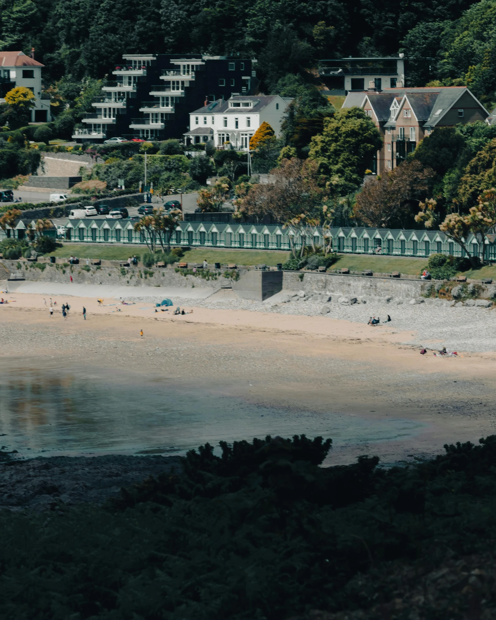 a beach with buildings on the other side