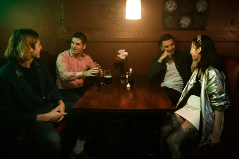 some people sitting around a table drinking beer