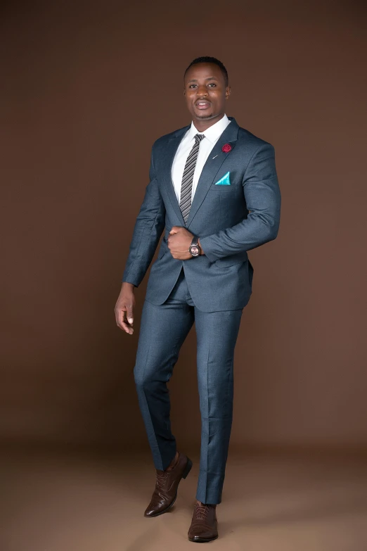 an african american man dressed in a blue suit and tie