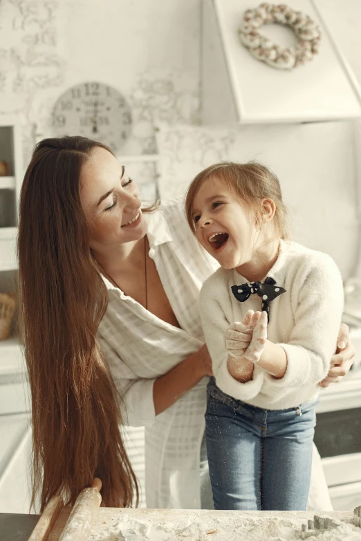 two women and one child in a room with white walls