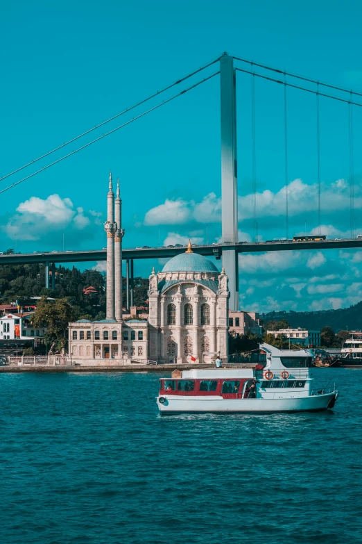 a boat sailing in the water near the building