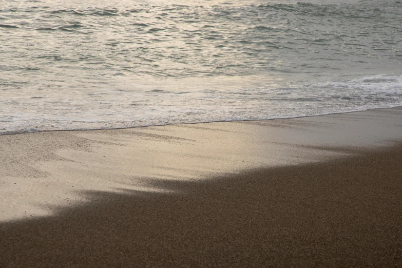 water flowing along the beach as it sets on fire