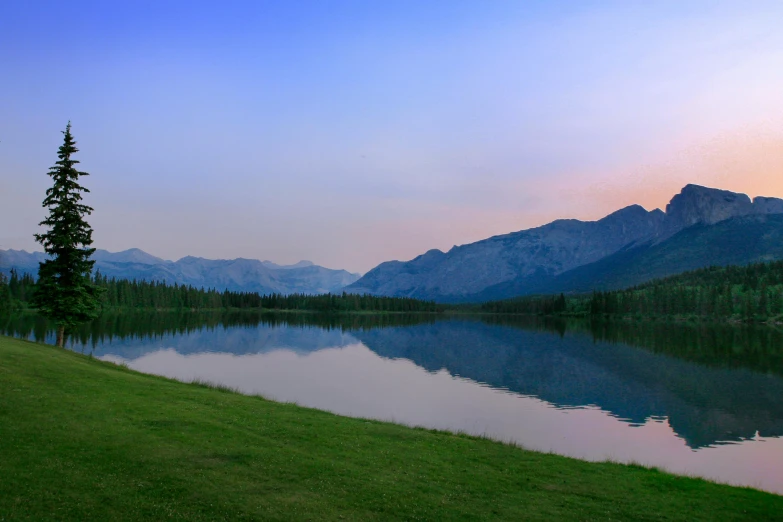 the mountain is reflected in the still waters