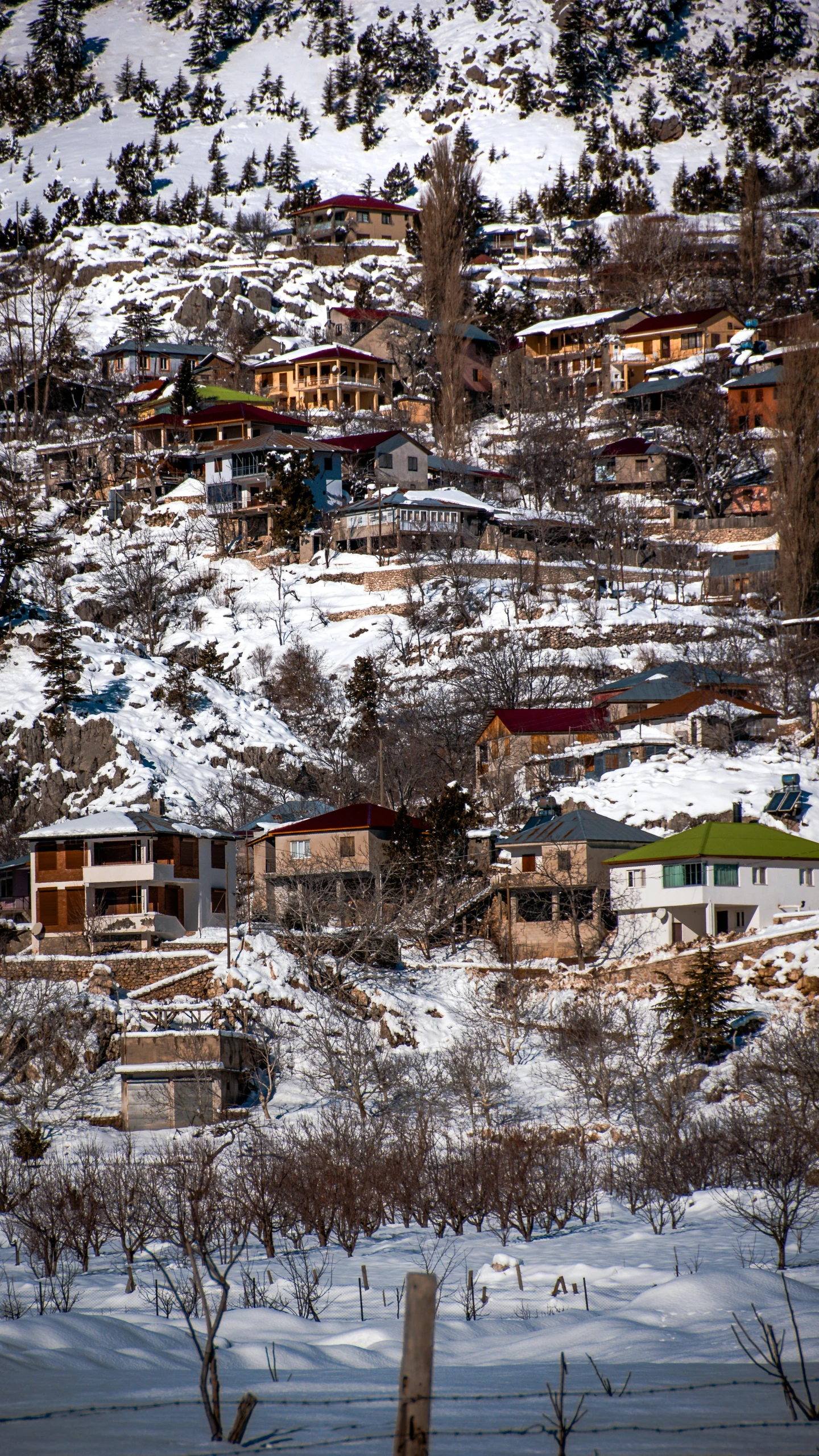 a snowy village with a view on snow covered hillside