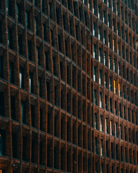 a tall brick building with windows and yellow street lights