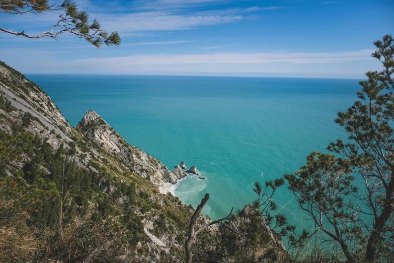 the view from a hill of ocean and rocks