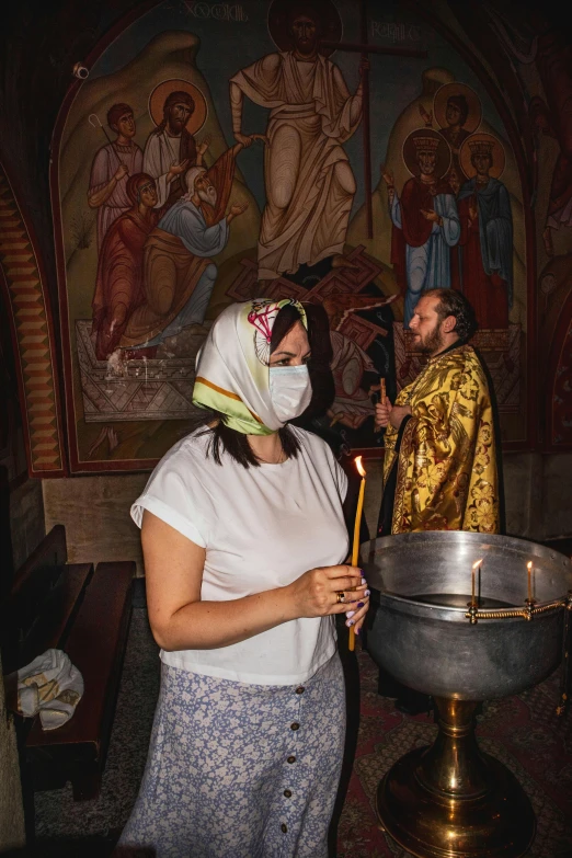 a woman is standing next to a man with a face mask