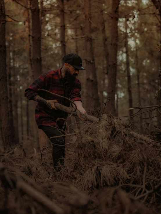 a man with a large sawdust cuts down some trees