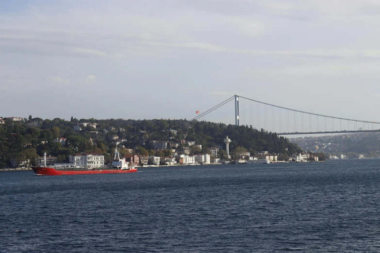 a large boat is on the water next to a bridge