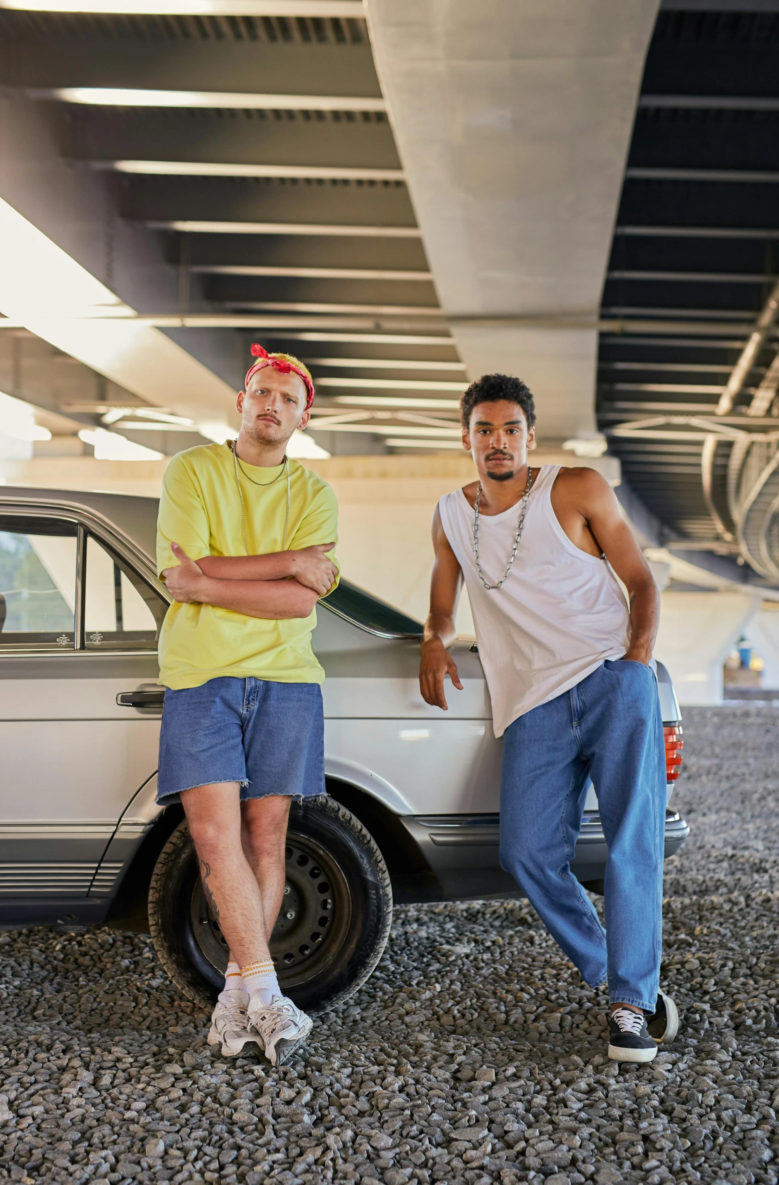 two men standing in front of a car