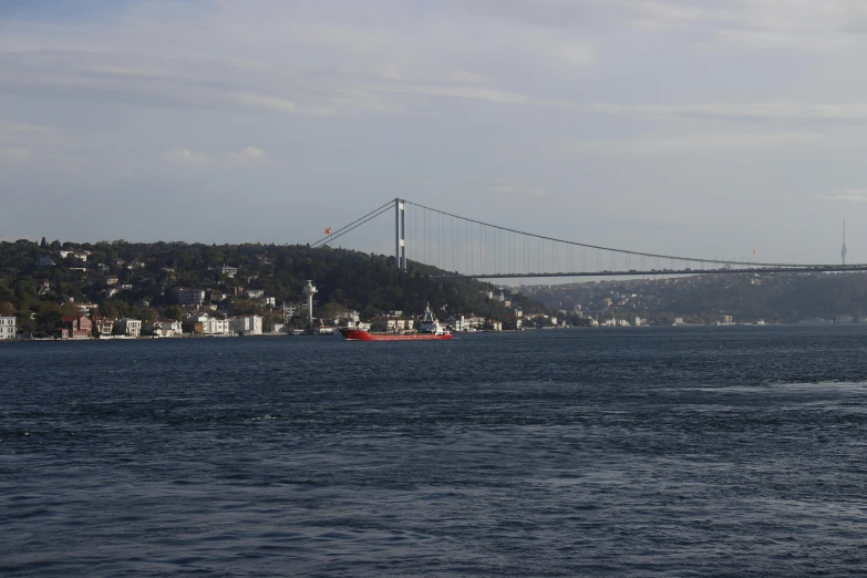 a boat travels down a river under a bridge