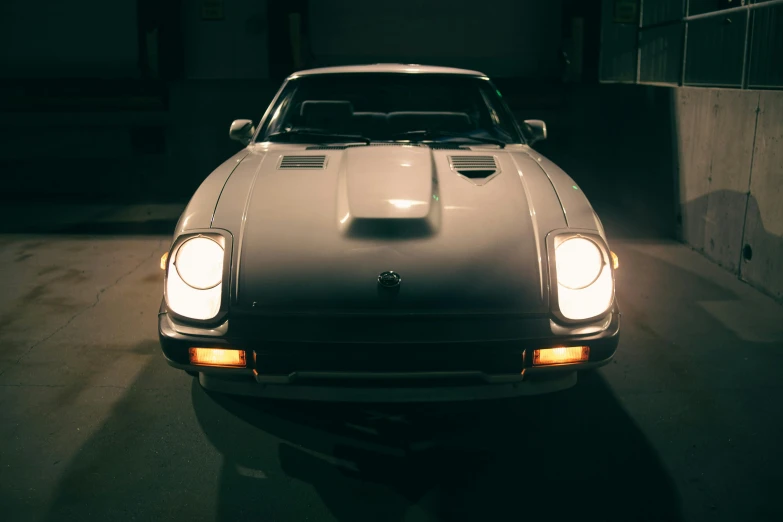 an older sports car with headlight shines on the side