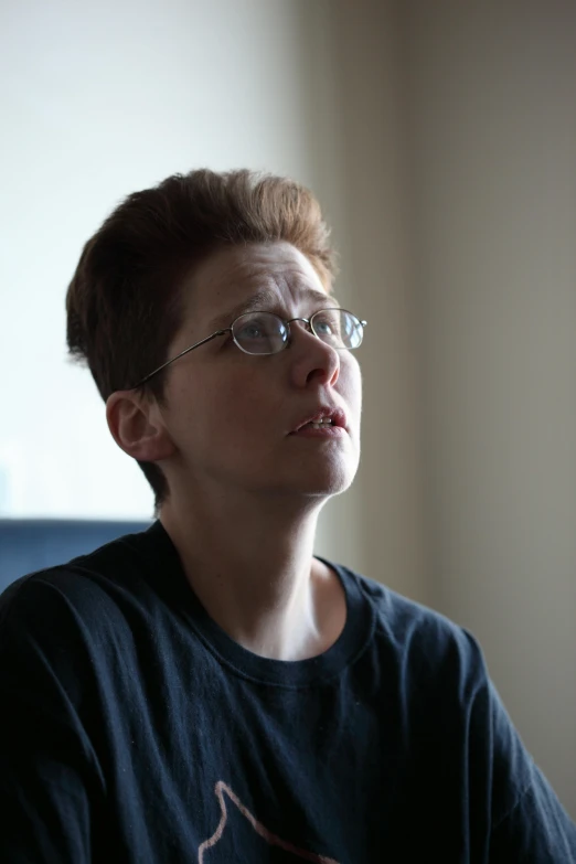 a man with short hair and glasses staring ahead