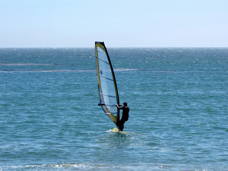 a person is riding on top of a small sailboat