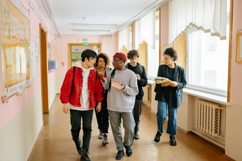 several young men are walking down a corridor