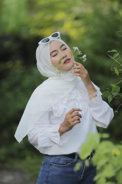 the woman is holding a flower in her hand