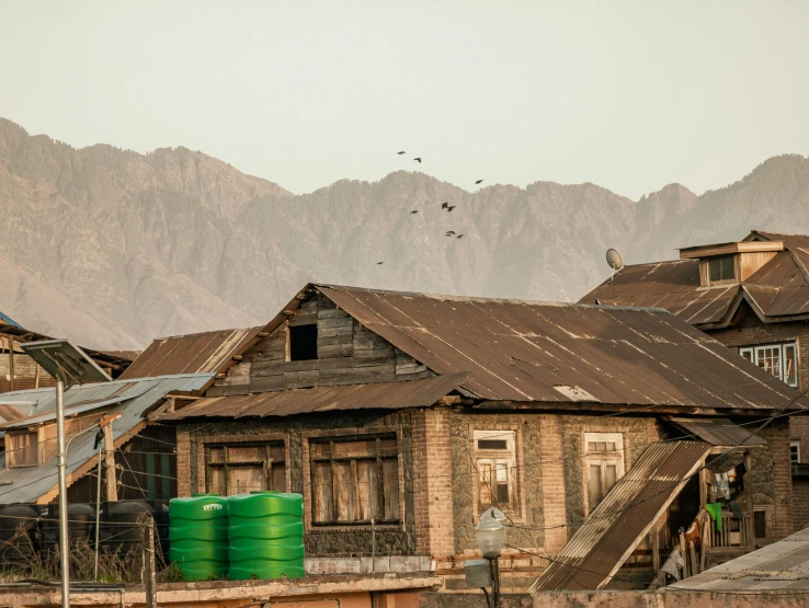 a building with a rusty roof and mountain view