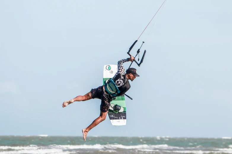 a man riding on top of a parasail over the ocean