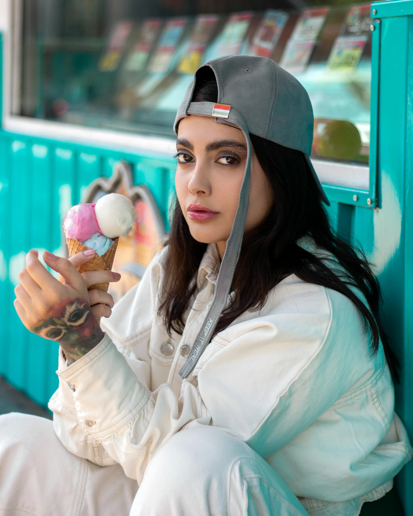 a girl holding an ice cream cone and staring up