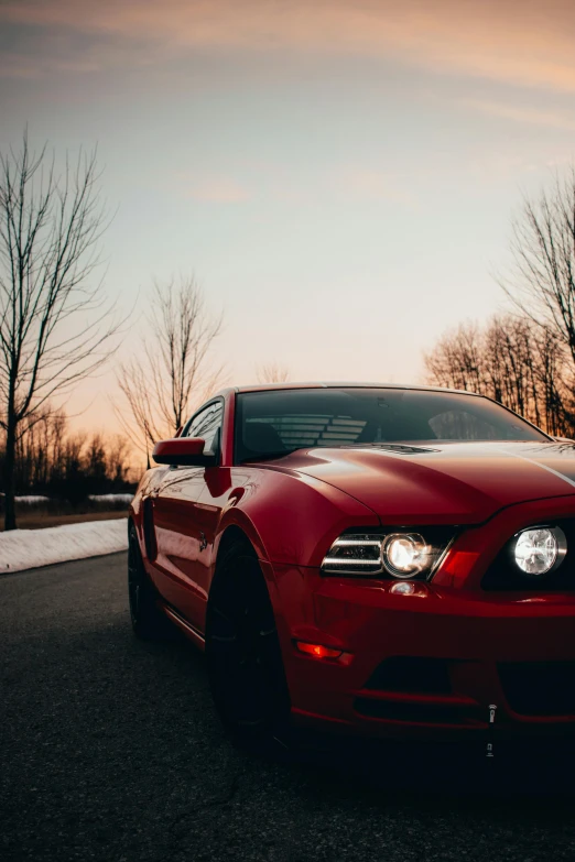 a red sports car with headlights on