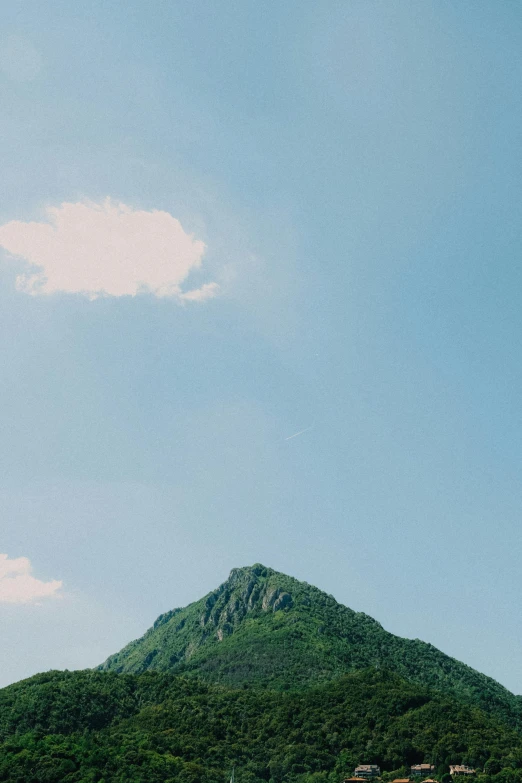 a mountain side is seen with the sky in the background