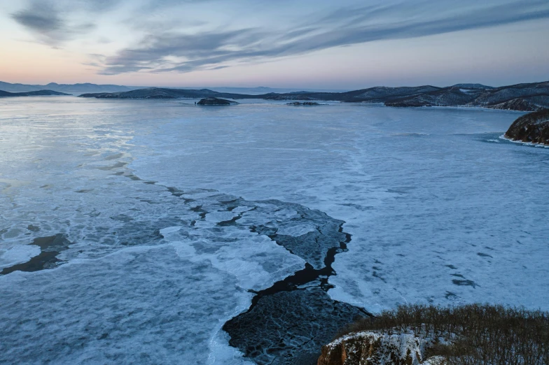 the water is frozen over as it goes down the river