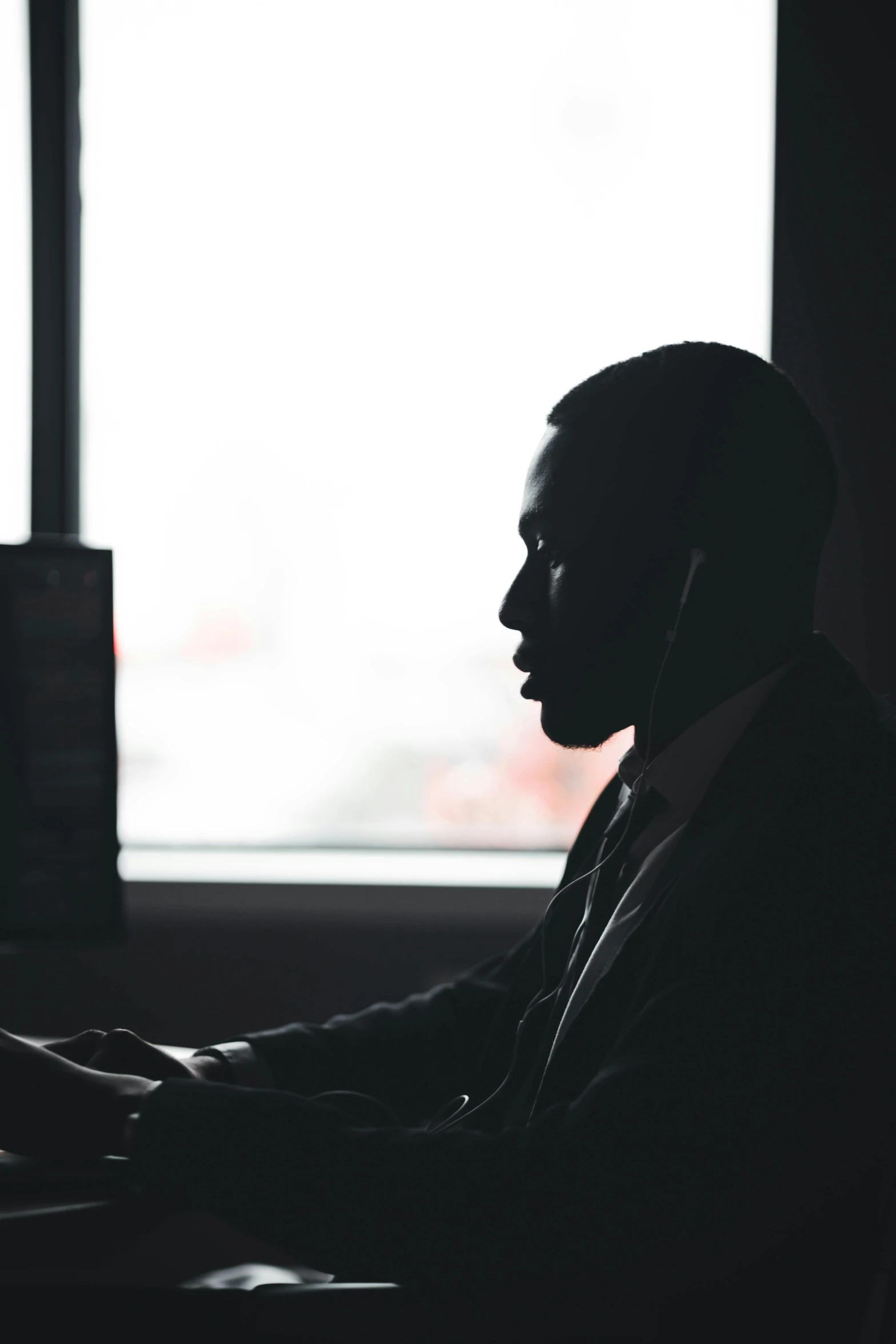 a man is typing on his computer in the dark