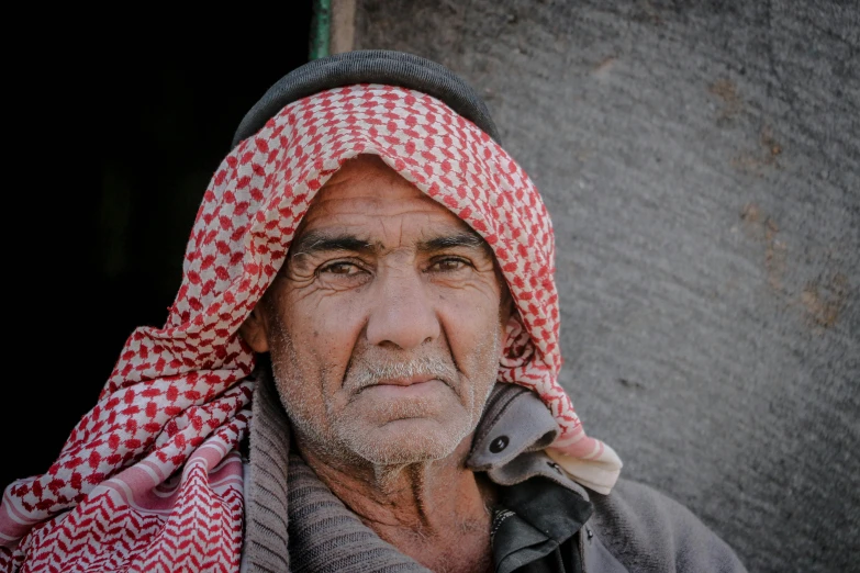 an old man in a red and white hat talking on his cell phone