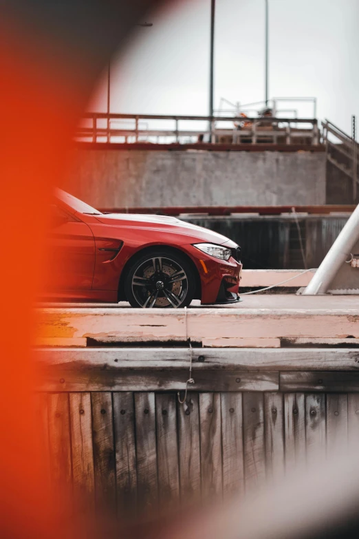 a red sports car on some train tracks