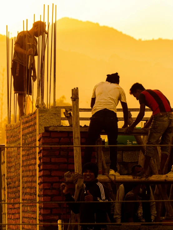 some men standing on top of a brick building