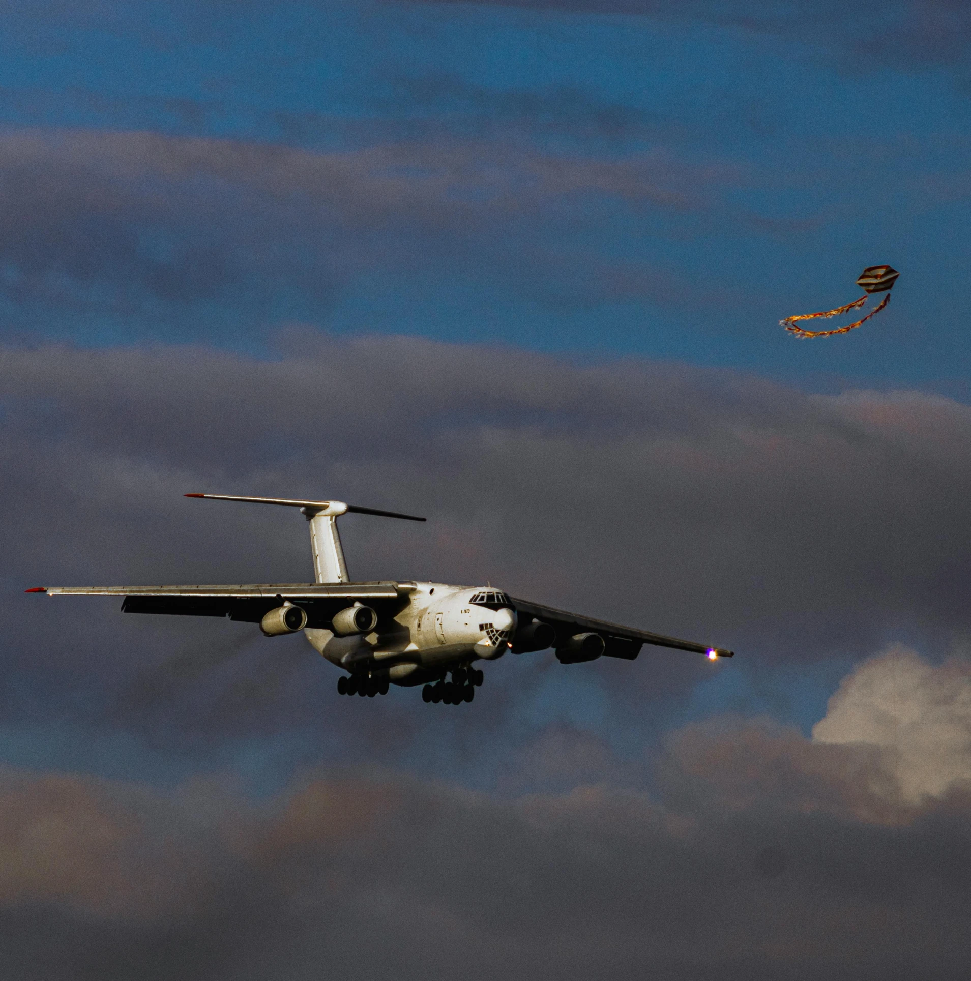 a military plane is flying high in the sky