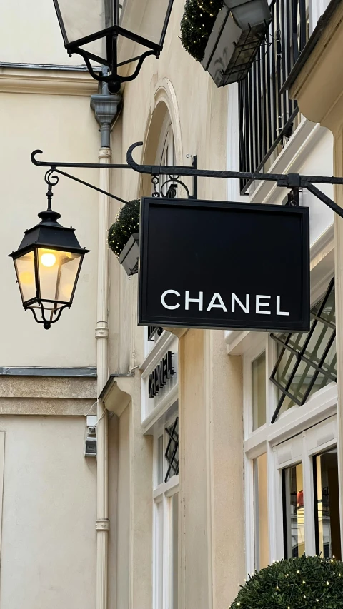a chanel sign hangs from the side of the building